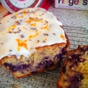 Blueberry and Apple loaf decorated with white icing, orange peel and lavender flowers